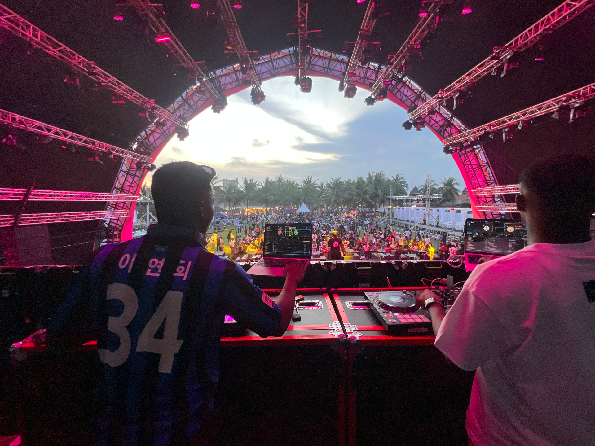 DJ Phantom performing at a festival under purple and cyan stage lights